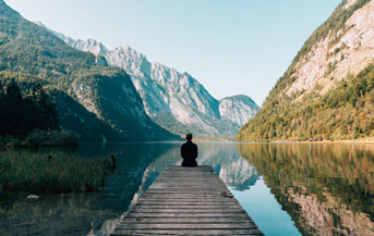 Man on dock in mountains