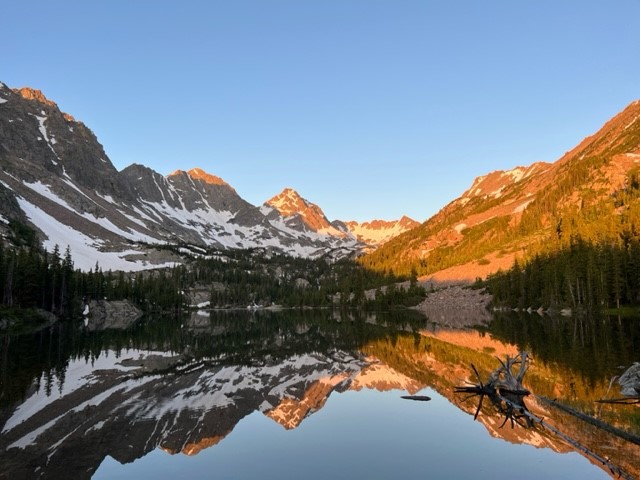 alpine lake surrounded by mountain peaks